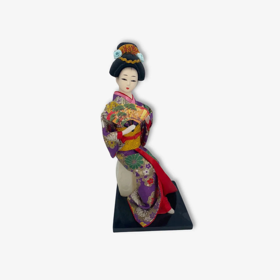Figura de geisha japonesa con hermoso kimono morado